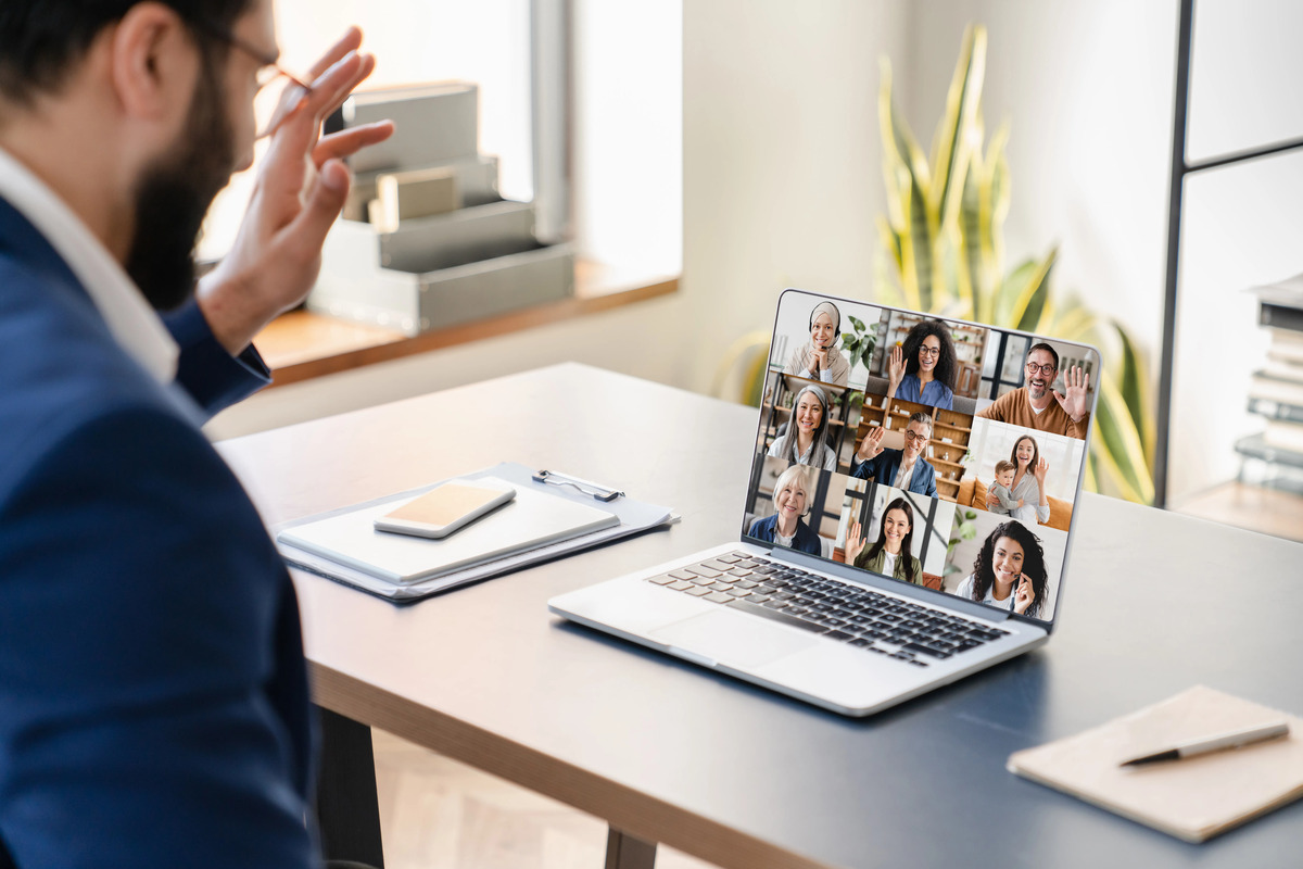 remote worker has a videoconference, online conversation with colleagues on a laptop