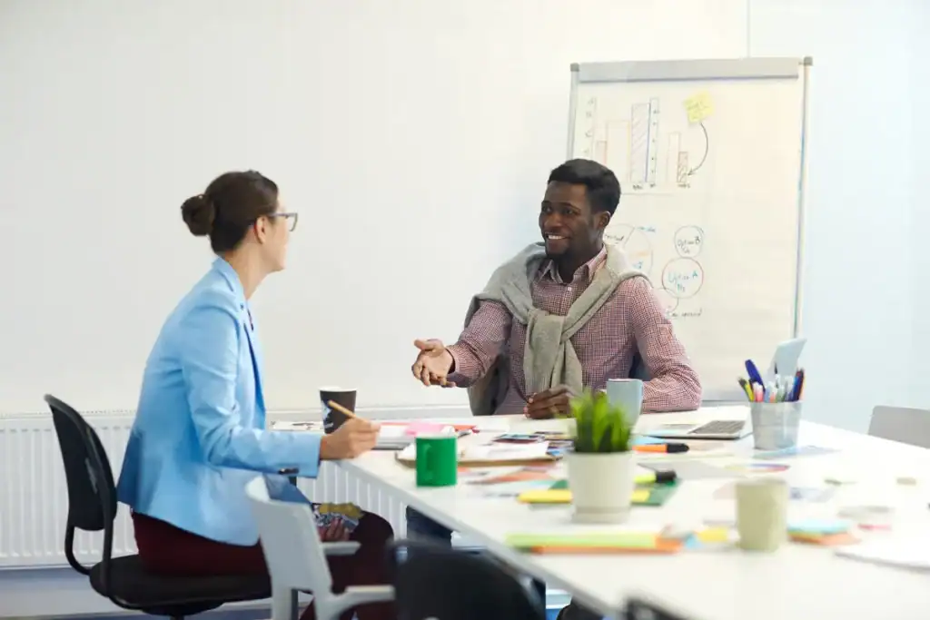 Young person explaining something to a colleague or peer group member