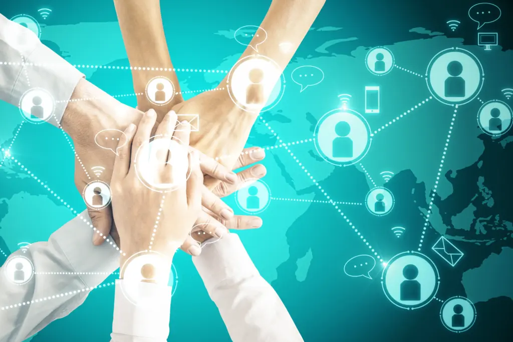 Five hands united over a world map, surrounded by networking icons, symbolizing effective global collaboration and right sourcing.