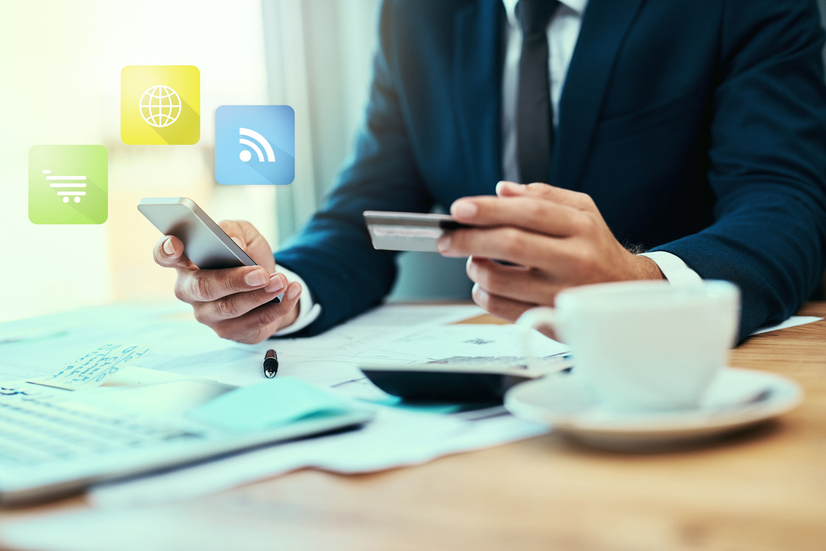 Photo of an unidentifiable businessman making a credit card payment online