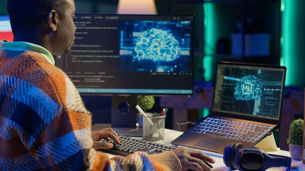Programmer manages artificial intelligence and machine learning code and scripts on a PC with two monitors