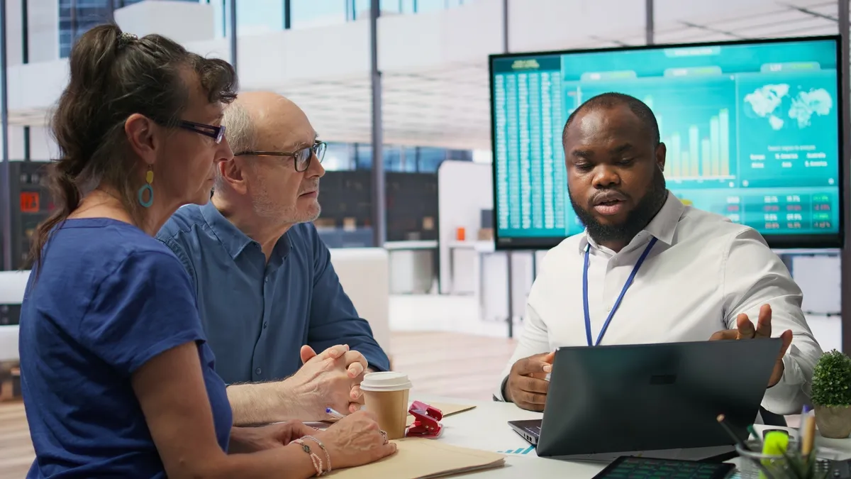 couple talking to a person explaining their needs to them