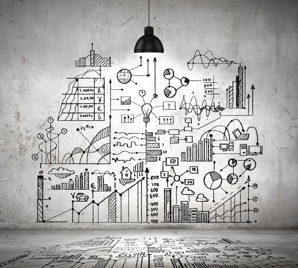 Illustration of business strategy and data visualization concepts drawn on a wall, symbolizing user-centered UX design processes.