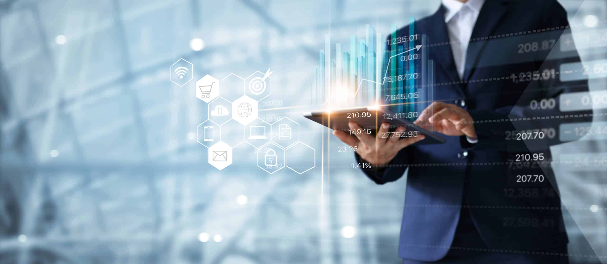 Business professional using a tablet with digital financial data, analytics, and technology icons overlaying the image, symbolizing digital transformation.