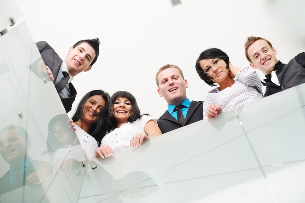 Happy business professionals celebrating success at Catalyst UX, a top design and UX development firm.
