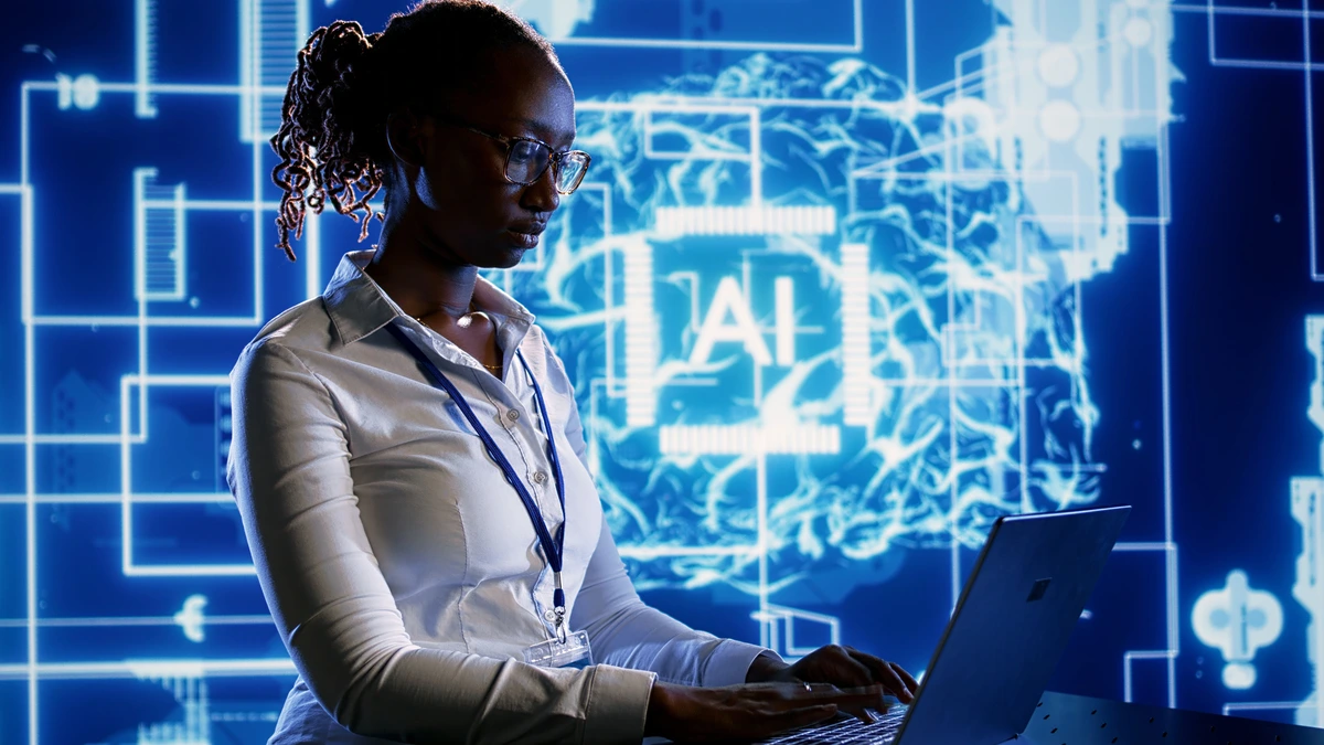 Engineer helps build AI on a laptop with blue background and AI in the background