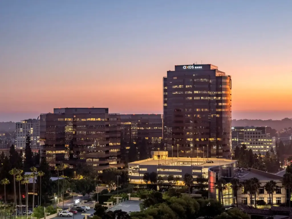The Axos Bank corporate office building at sunset, representing the large-scale commercial banking operations and $12B in assets supported by unosquare's full-stack engineering and platform modernization.