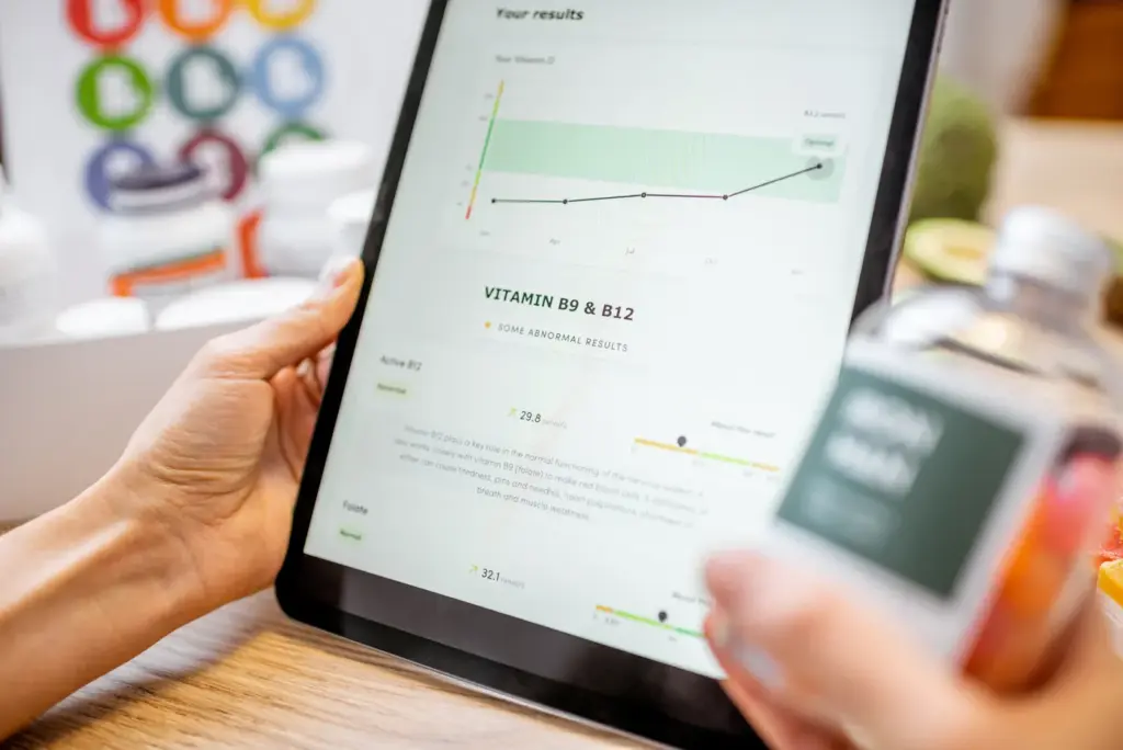 CheckedUp telemedicine tablet interface showing personalized health results with Vitamin B9 and B12 levels and trend analysis for patient consultation