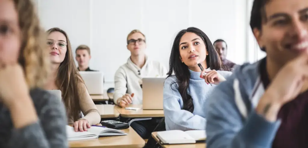 A classroom of engaged university students using Harvard Business Publishing's digital learning platforms.