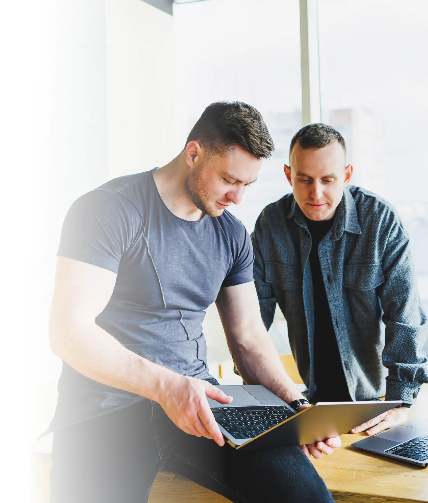 Two engineers reviewing software on a laptop